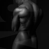 Black and white fine art photo of a nude black man posterior view from head to mid thigh with arms crossed, looking downwards.