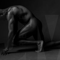 Black and white fine art photo showing a sideview of a nude black man from head to mid thigh with one arm bent and chin resting on closed fist.