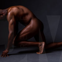 Fine art photo showing a sideview of a nude black man from head to mid thigh with one arm bent and chin resting on closed fist.