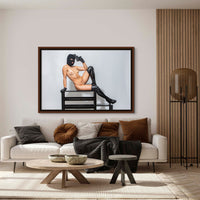 Framed fine art photo hanging above a sofa in a stylish livingroom of a nude woman wearing a black balaclava and black leather gloves and thigh high boots lounging on a bench with one arm bent and resting her handgun against her head in a seductive way.
