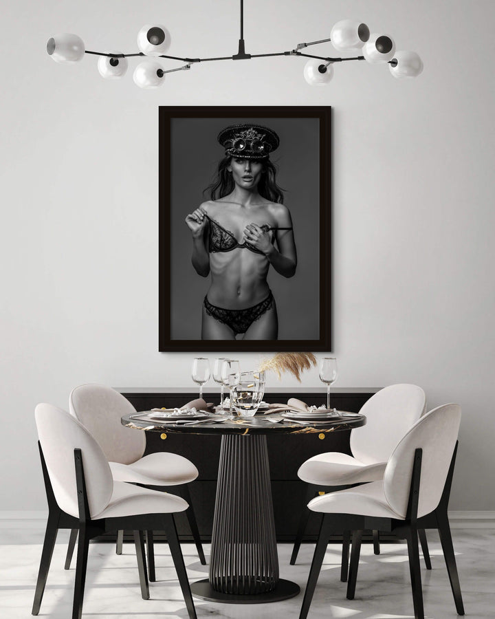 Provocative framed photo hanging above a modern dining room.
