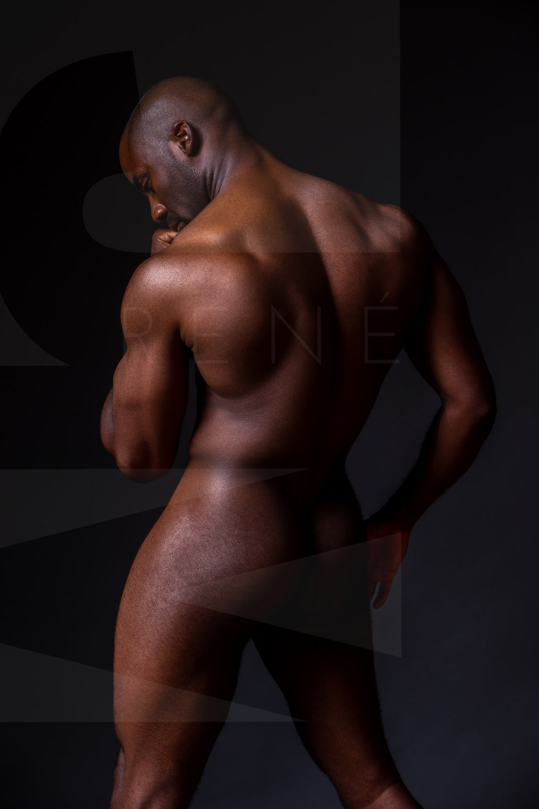 Fine art photo of a nude black man posterior view from head to mid thigh with one arm bent and chin resting on closed fist.