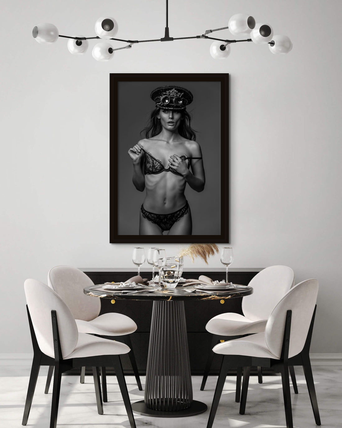 Framed fine art photo hanging in a modern contemporary dining room showing a gorgeous woman wearing a lace bra and panties with a steampunk style captain's hat and round goggles on her head